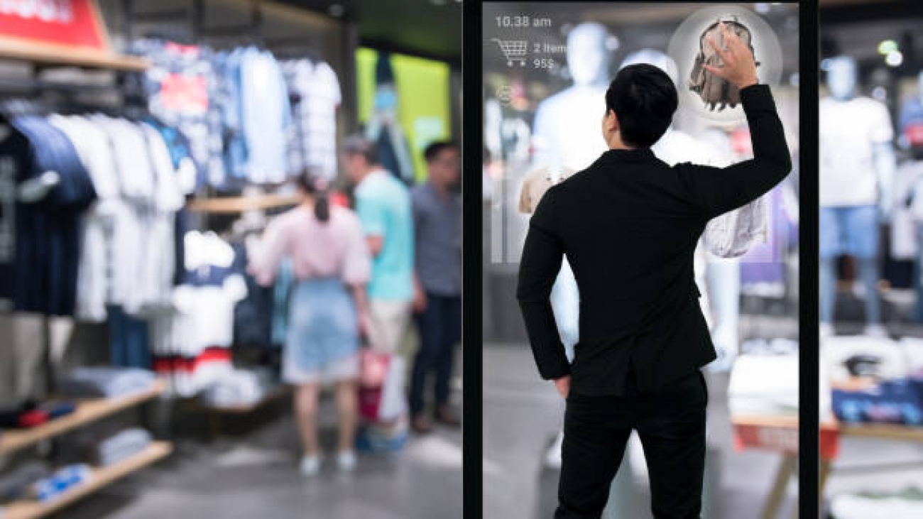 Augmented reality marketing technology concept. Businessman using smart glass digital signage , AR application to select and buy items in retail fashion shop.